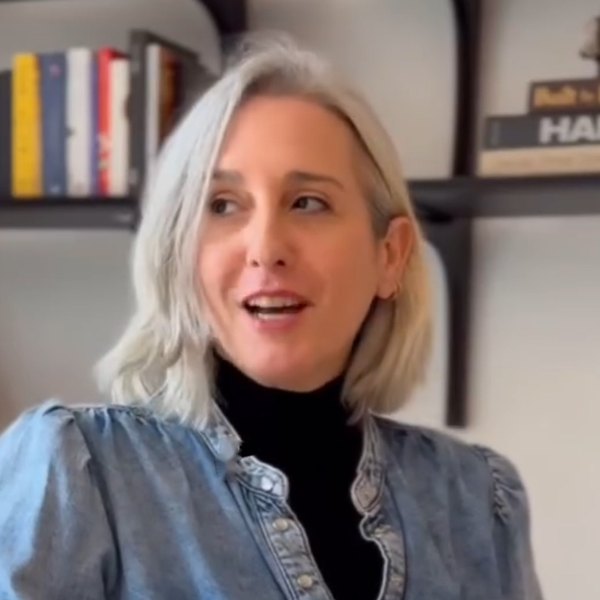 Maya Carni, architect and buying agent, in conversation in front of shelves of architecture books